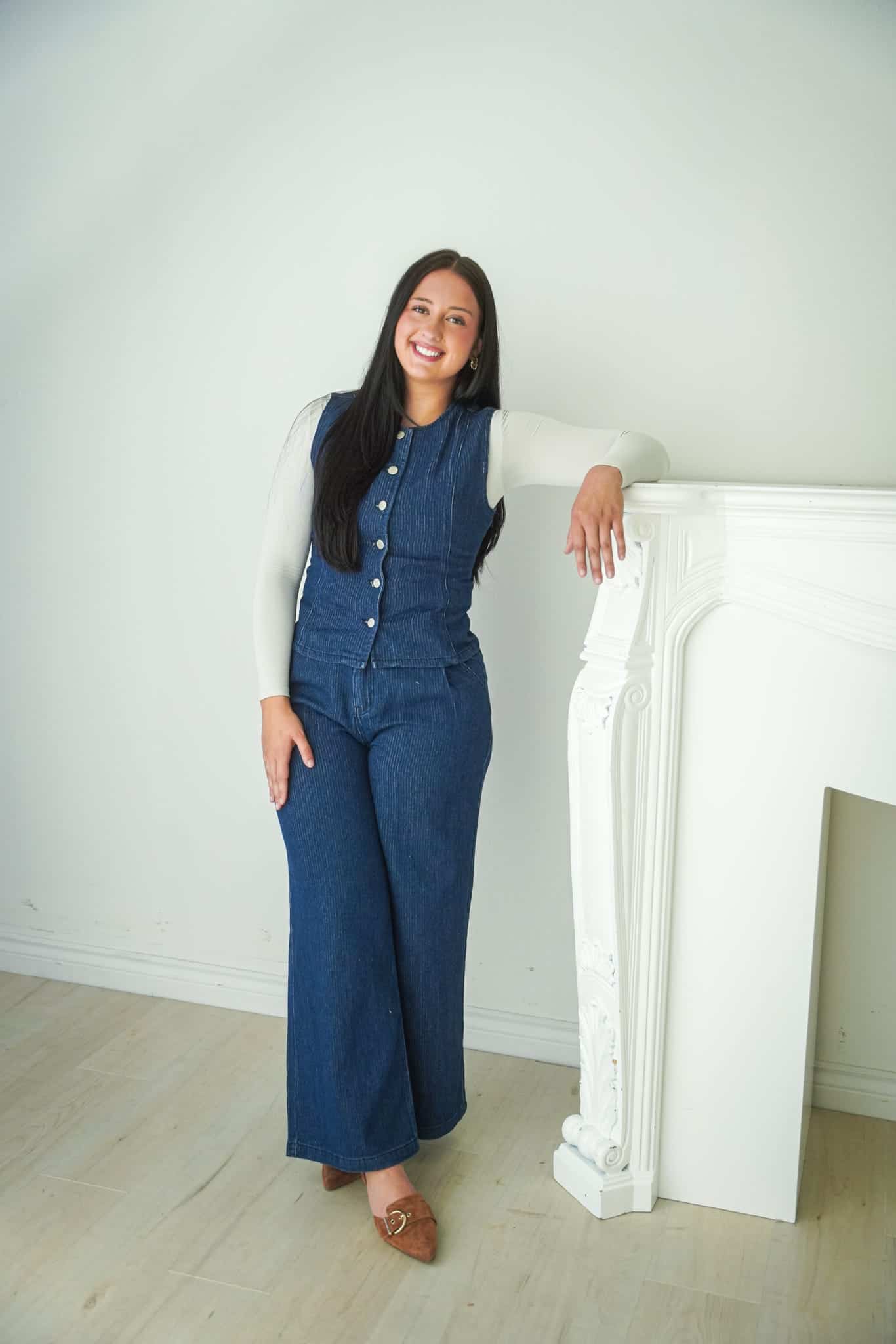 Rosie Owen, Northwest Arkansas real estate agent, standing beside a white fireplace